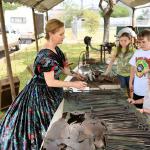 Reenactor demonstrating kitchen tools.